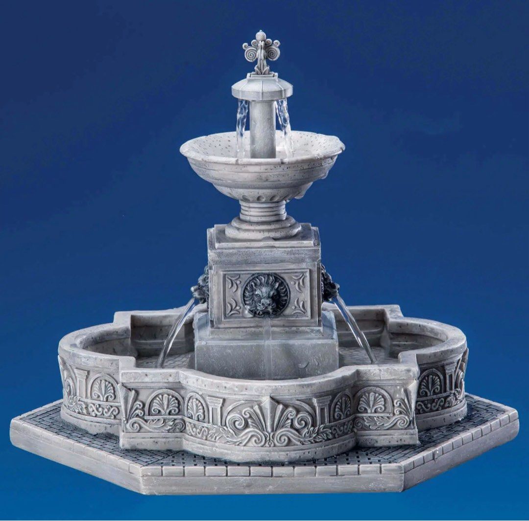 Lemax Modular Fountain (Category: Figurines & Statues) located in Santiago. Submitted by kitalpanga (Listing ID 1465064913, Image 3). Description: With 220v lemax adaptor. - Miniature decorative water fountain with a classic tiered stone design - Features detailed lion head water spouts and a patterned basin - Includes two charming vintage-style figurines: a man with a bicycle and a man with a cane and hat - Beautiful grey finish that mimics aged