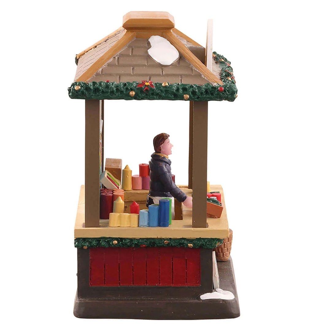 Lemax Natalie’s Candle Creations lighted (Category: Figurines & Statues) located in Santiago. Submitted by kitalpanga (Listing ID 1465057703, Image 2). Description: - Hand-painted miniature Christmas village candle shop stall - Features a festive vendor surrounded by colorful candles and hanging displays - Detailed design with snow-dusted roof, evergreen garlands, and poinsettia accents - Made of durable polyresin material - Great addition to hol