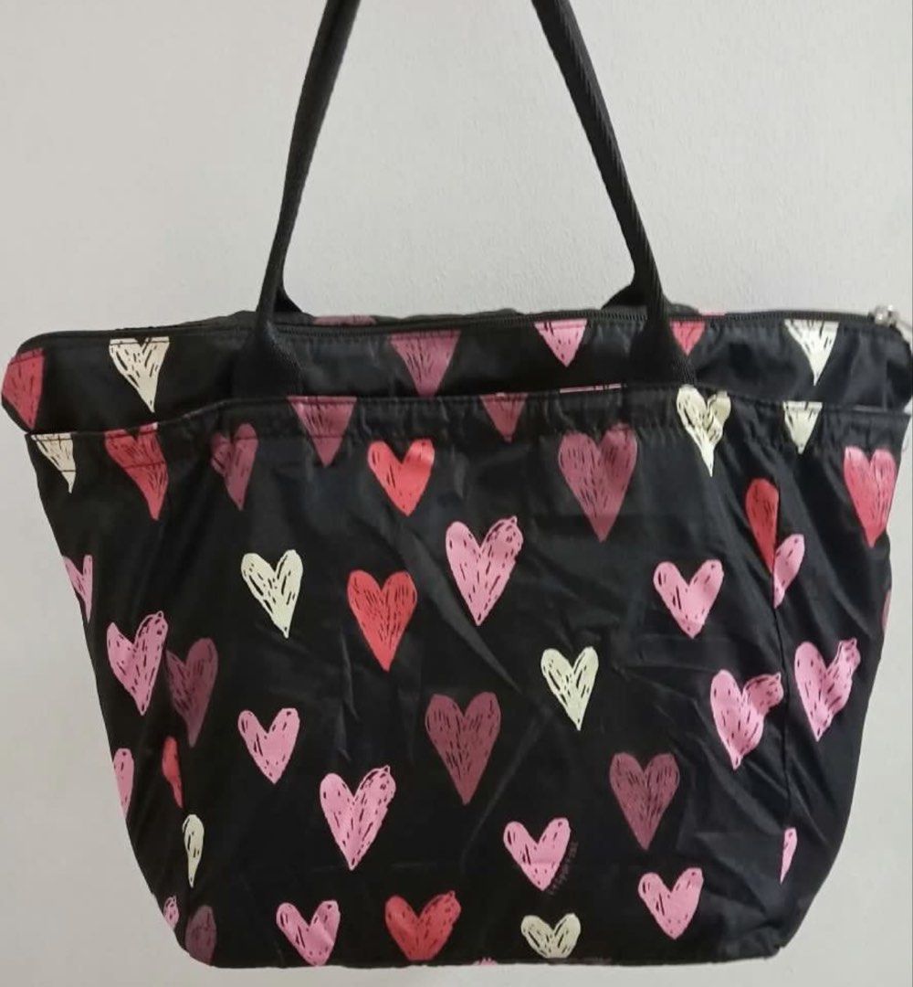 LeSportsac Black Heart Pattern Tote Bag (Category: Tote Bags) located in Manila. Submitted by edensy (Listing ID 1465079280, Image 2). Description: - Brand: LeSportsac - Design: Playful all-over heart print with branded ribbon trim - Colors: Classic black exterior with a vibrant red interior lining - Closure: Secure top zip closure - Handles: Comfortable dual carrying handles - Storage: Roomy main compartment fits all your daily essentials - Mode