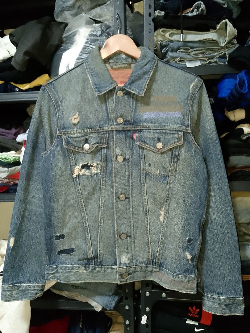 Levi's 501 Distressed Denim Jacket Size M (Category: Coats, Jackets and Outerwear) located in Manila. Submitted by mjthrifted_second (Listing ID 1465017436, Image 1). Description: - Brand: Levi's 501 Trucker Jacket - Size: Medium -Dimes: 21/25 - Color/Wash: Medium wash blue - Material: 100% cotton denim - Origin: Made in the Philippines - Details: Distressed finish with factory rips, abrasions, and custom embroidery patch on upper chest - Closure