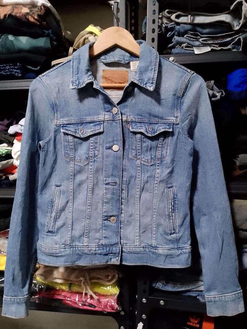 Levi's Denim Jacket Light Wash XS (Category: Coats, Jackets and Outerwear) located in Manila. Submitted by mjthrifted_second (Listing ID 1465026772, Image 1). Description: - Brand: Levi's - Style: Classic denim jacket - Color: Light wash blue - Size: XS (Made in Sri Lanka) -Dimes: 17/21 - Material: 100% cotton - Features: Front button closure with metal shanks, two chest flap pockets, two side welt pockets, and a regular collar - Condition: Excel