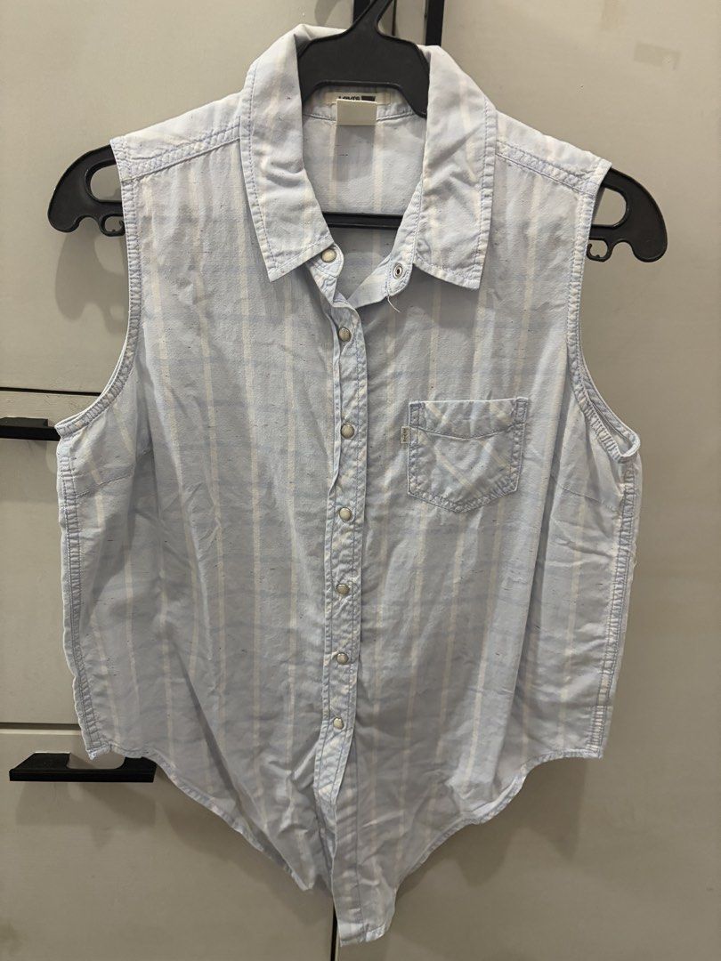 Levi's Light Blue Striped Sleeveless Button-Up Tie-Front Top (Category: Sleeveless) located in Las Pinas. Submitted by salmon._.sashimi (Listing ID 1465072692, Image 1). Description: - Brand: Levi's - Style: Light blue & white striped sleeveless denim shirt - Details: Pointed collar, metal snap-front closure, single chest pocket with brand tag, curved front-tie hem - Material: Lightweight denim, ideal for the PH weather - Perfect for: Casual days