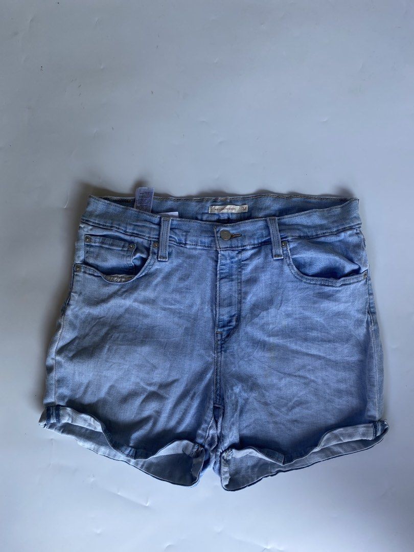 Levi's Mid Length Denim Shorts Size 32 (Category: Shorts) located in Manila. Submitted by deguertoje73072 (Listing ID 1465008789, Image 2). Description: - Brand: Levi's - Style: Mid-length denim shorts with cuffed hems - Wash: Light blue - Size: 32 - Details: Classic five-pocket styling, button fly, leather back patch, signature red tab - Condition: Great staple piece for warm weather.