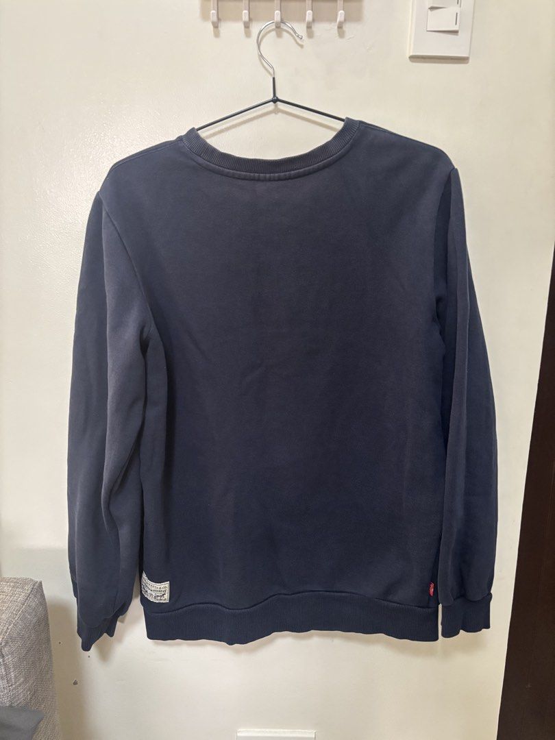 Levi's Navy Blue Sweatshirt Since 1873 Logo (Category: Coats, Jackets and Outerwear) located in Meycauayan. Submitted by retroselectionph (Listing ID 1465009461, Image 2). Description: - Authentic Levi's crew neck sweatshirt in classic navy blue - Features bold red and white 'Levi's Since 1873' chest applique - Comfortable fit with ribbed cuffs and hem for durability - Includes a small signature brand label patch near the bottom back corner - Gre