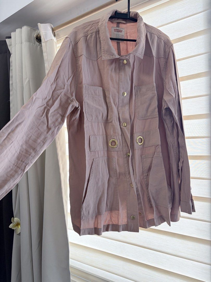 Levi's Pink Utility Jacket Size L (Category: Coats, Jackets and Outerwear) located in Manila. Submitted by cheska.closet18 (Listing ID 1465023056, Image 2). Description: - Brand/Model: Levi's Utility Jacket - Color: Pink - Size: L - Material: Lightweight, perfect for breezy days - Features: Multiple front pockets, button-down closure, metallic grommet details near the waist, collared neckline, and long sleeves with button cuffs - Condition: Excel