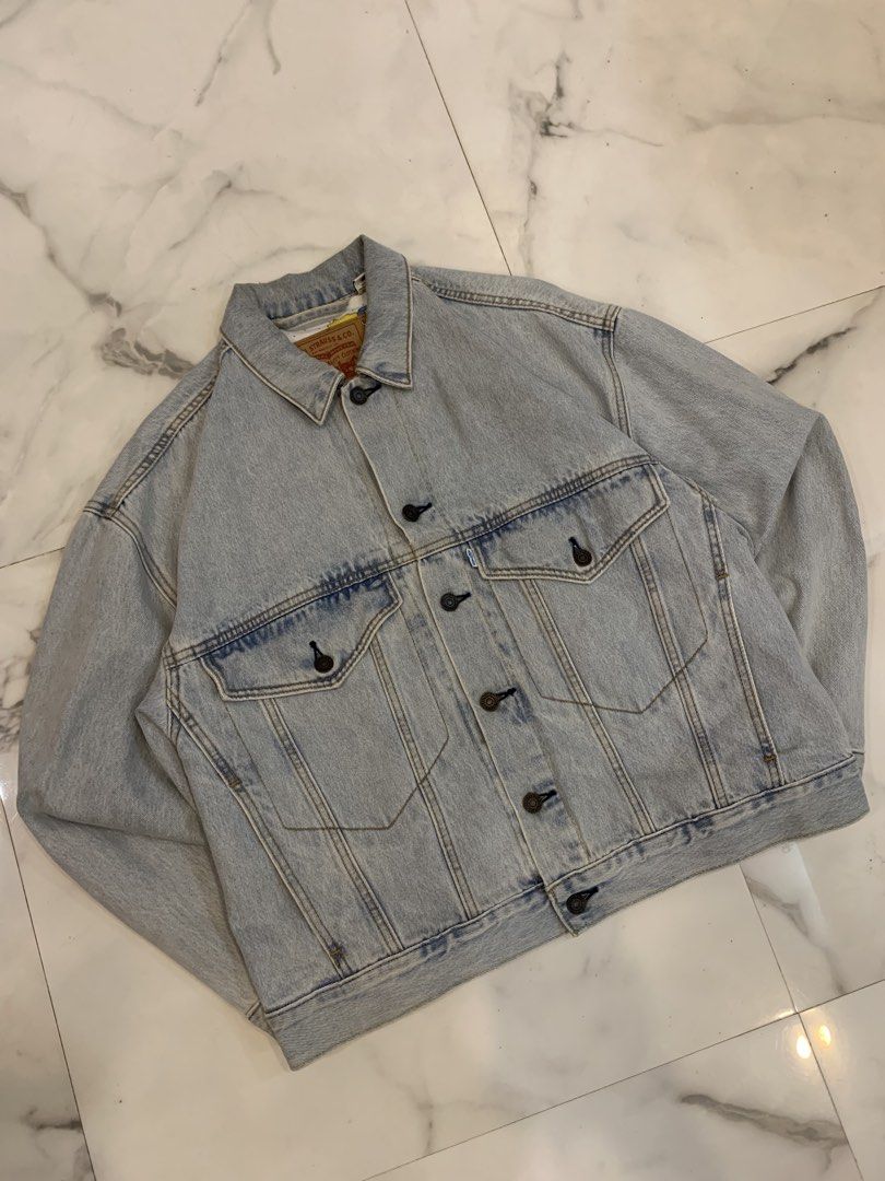 Levi's The Simpsons Bart Simpson Denim Jacket (Category: Coats, Jackets and Outerwear) located in Mapandan. Submitted by todaysthrift.hqk (Listing ID 1465002919, Image 1). Description: - Brand: Levi's - Wash: Light wash denim - Design: Embroidered Bart Simpson drinking a Squishee on the back - Lining: Fun all-over Simpsons character print on the inside - Pockets: Dual chest pockets and convenient side pockets - Style: Classic button-up front - Co