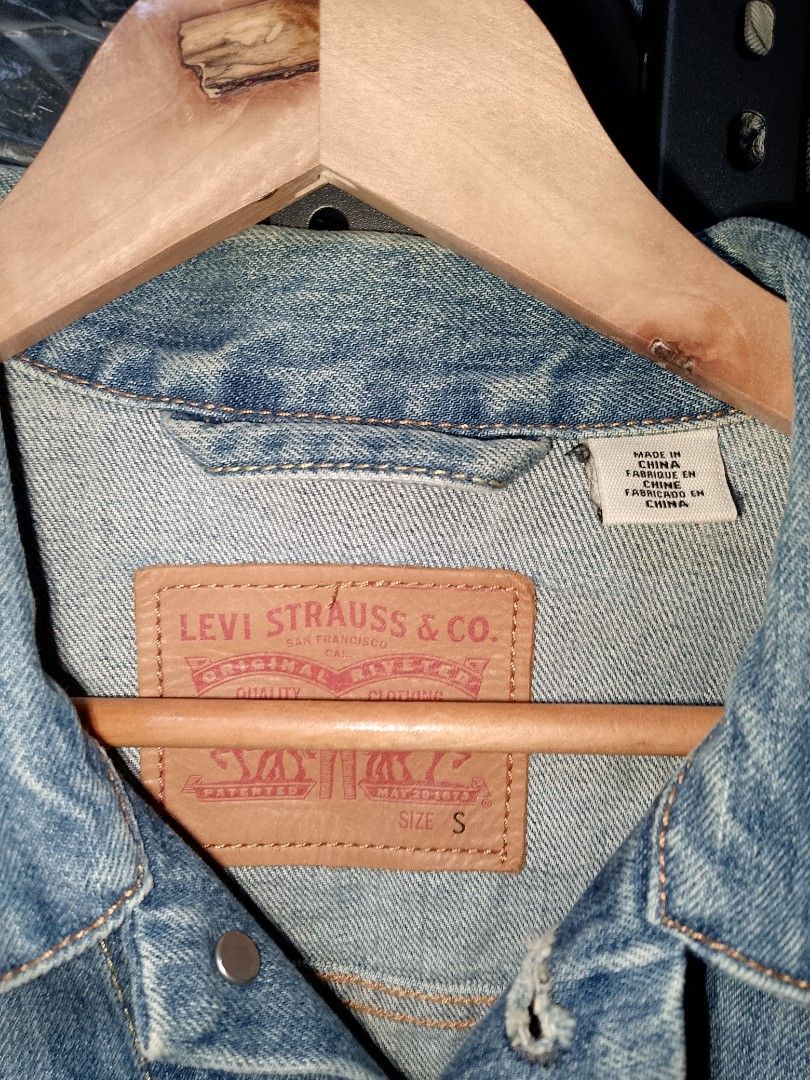 Levi's Trucker Denim Jacket Light Wash Size S (Category: Coats, Jackets and Outerwear) located in Manila. Submitted by mjthrifted_second (Listing ID 1465021880, Image 2). Description: - Brand: Levi's - Style: Classic denim jacket with traditional button-up front - Color: Light wash blue - Size: Small (Regular fit) -Dimes: 20/25 - Features: Dual chest flap pockets, side welt pockets, iconic leather patch, and red tab - Condition: Excellent, versat