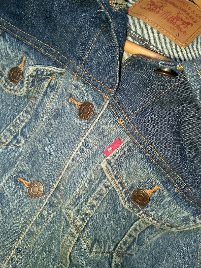 Levi's Two-Tone Denim Jacket Size S (Category: Coats, Jackets and Outerwear) located in Manila. Submitted by mjthrifted_second (Listing ID 1465024635, Image 2). Description: - Brand: Levi's - Style: Cool two-tone design (dark indigo top with lighter wash body and sleeves) - Size: Small (fits true to size) - Features: Button-up front, two buttoned chest pockets with iconic red tab, and vertical side welt pockets - Details: Levi's leather patch at 