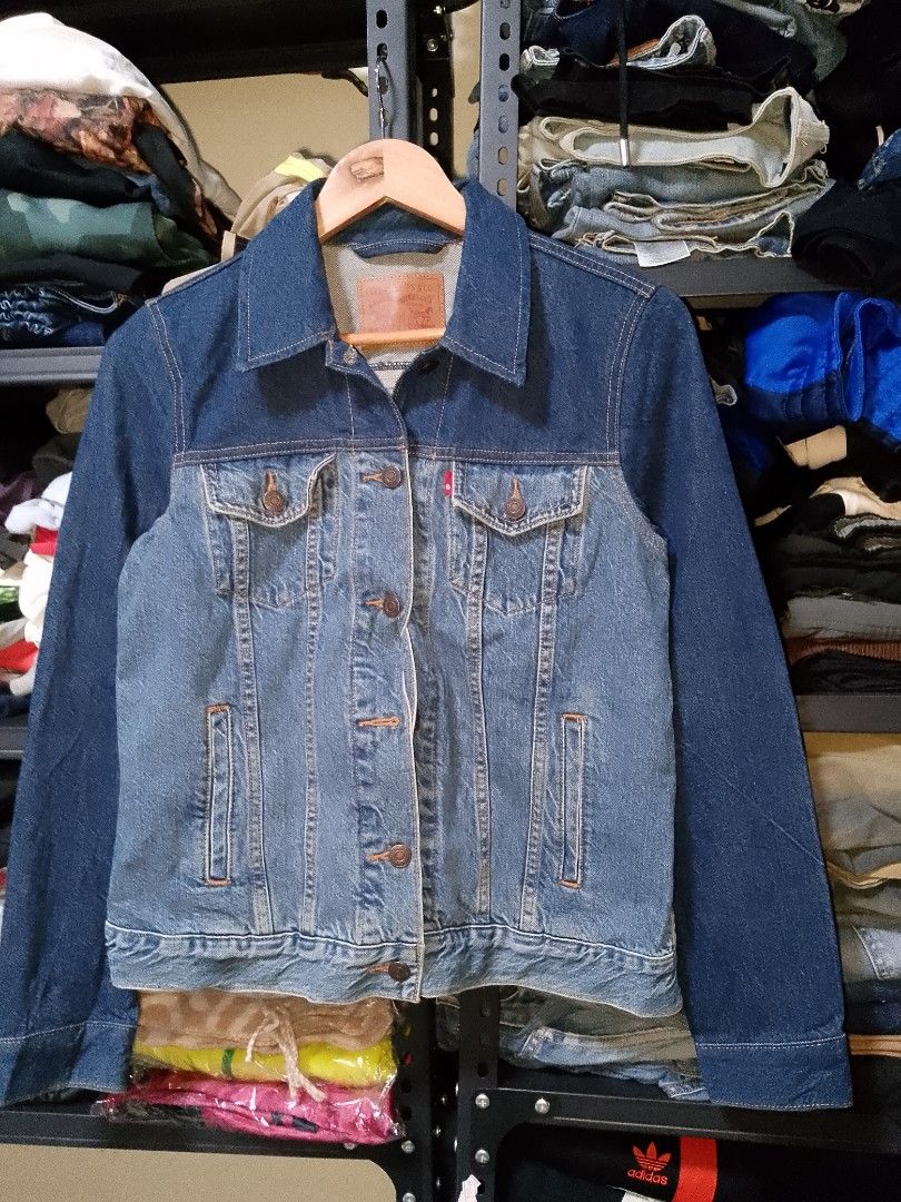 Levi's Two-Tone Denim Jacket Size S (Category: Coats, Jackets and Outerwear) located in Manila. Submitted by mjthrifted_second (Listing ID 1465024635, Image 1). Description: - Brand: Levi's - Style: Cool two-tone design (dark indigo top with lighter wash body and sleeves) - Size: Small (fits true to size) - Features: Button-up front, two buttoned chest pockets with iconic red tab, and vertical side welt pockets - Details: Levi's leather patch at 