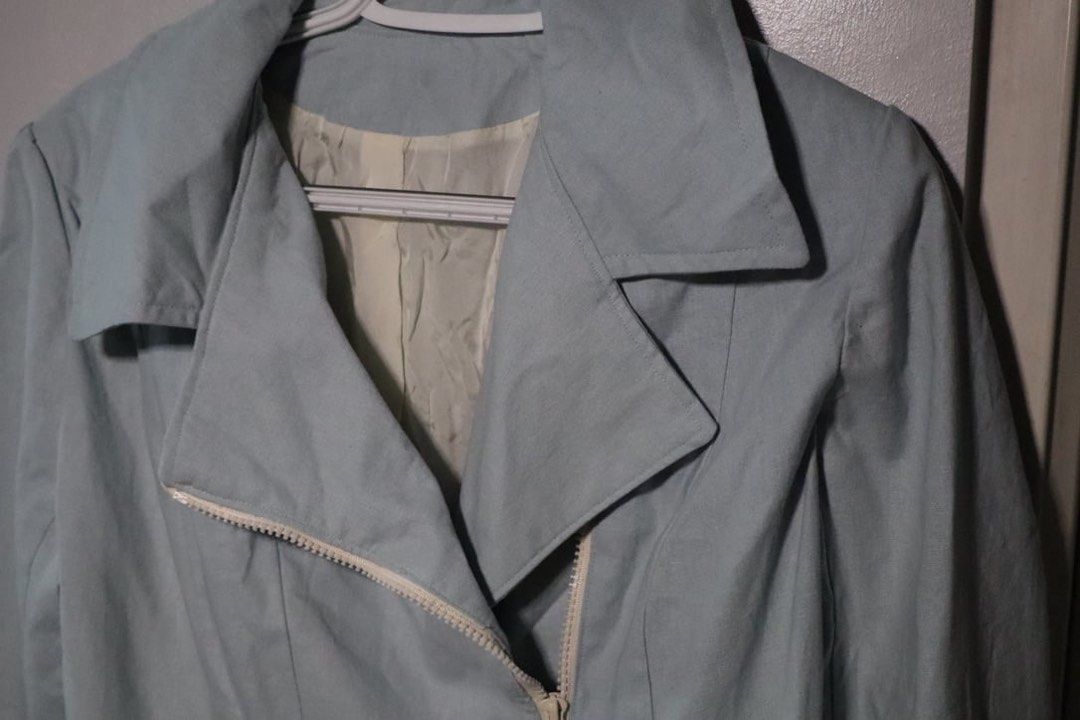 Light blue biker jacket with asymmetric zipper (Category: Coats, Jackets and Outerwear) located in Manila. Submitted by leivic (Listing ID 1465062499, Image 2). Description: - Color: Pastel blue with white lining - Style: Moto jacket, cropped length - Details: Asymmetric white front zipper, wide lapel collar, structured back paneling - Fabric: Clean finish, lightweight for breezy days - Condition: Excellent.