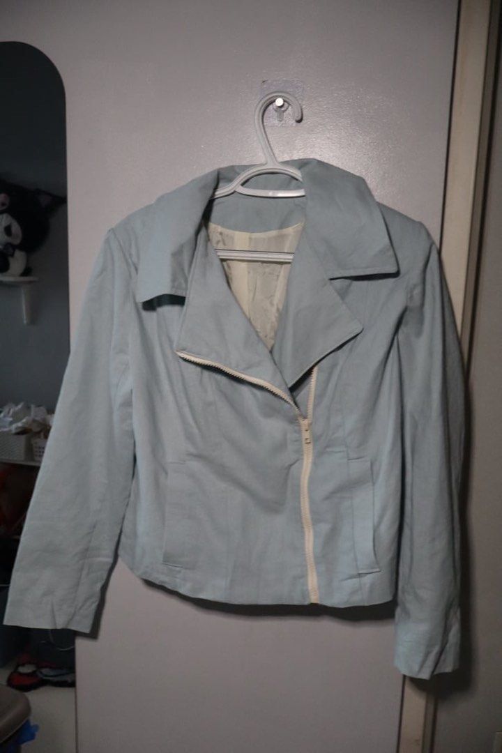 Light blue biker jacket with asymmetric zipper (Category: Coats, Jackets and Outerwear) located in Manila. Submitted by leivic (Listing ID 1465062499, Image 1). Description: - Color: Pastel blue with white lining - Style: Moto jacket, cropped length - Details: Asymmetric white front zipper, wide lapel collar, structured back paneling - Fabric: Clean finish, lightweight for breezy days - Condition: Excellent.