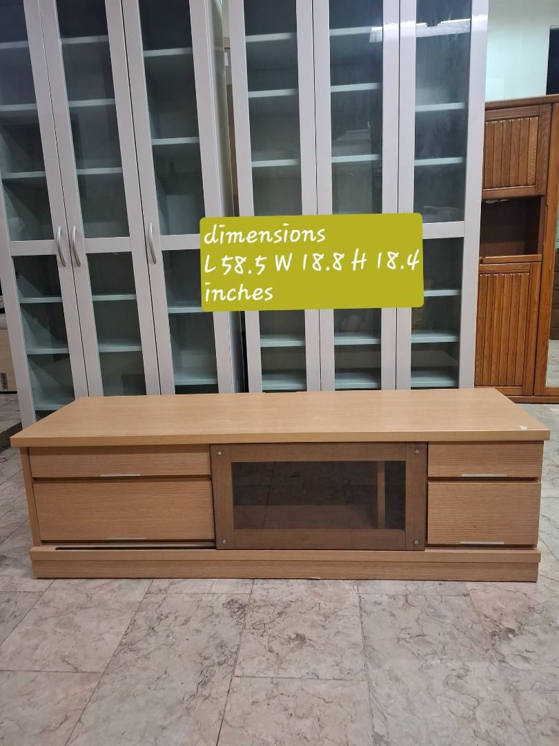 Light Oak TV Console Media Cabinet with Drawers (Category: TV Consoles) located in Quezon City. Submitted by japandemanila (Listing ID 1465005082, Image 1). Description: - Material & Finish: Wooden TV console with a stylish light oak finish - Storage: Two right-side drawers, one large left-side drawer, and a central glass-paneled sliding door cabinet - Media Space: Open interior shelf perfect for game consoles or media players - Dimensions: Rough