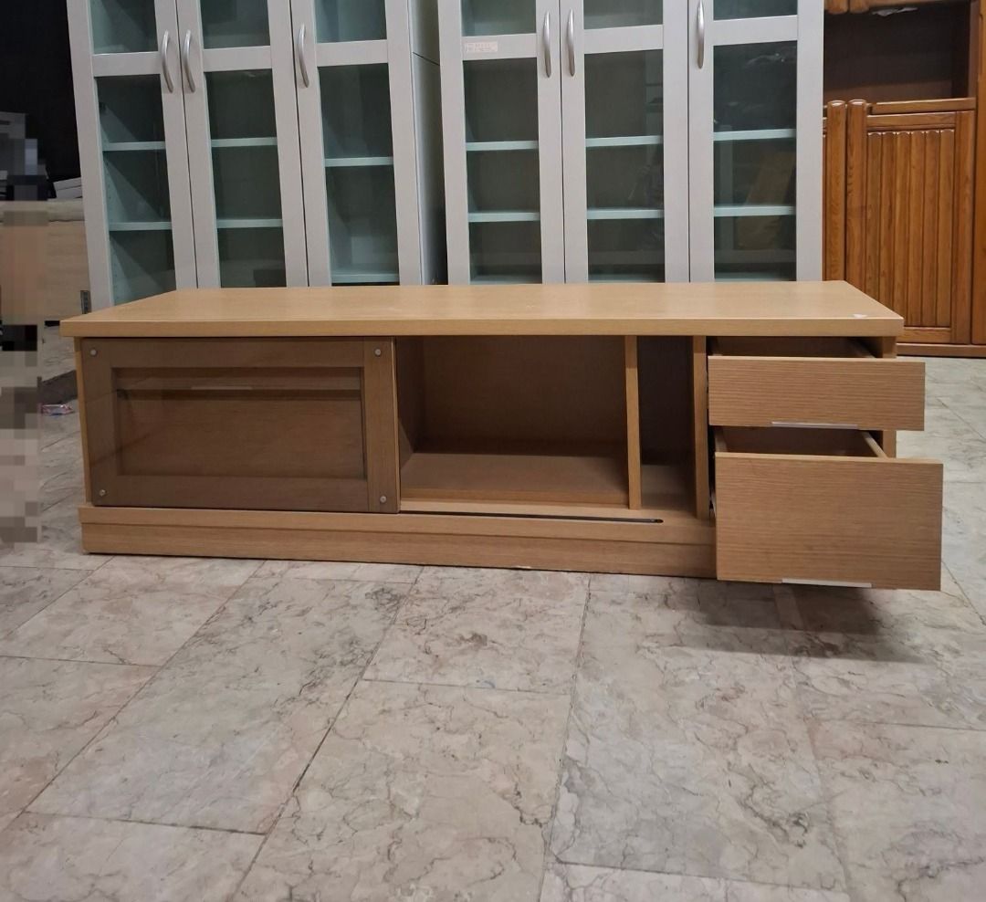 Light Oak TV Console Media Cabinet with Drawers (Category: TV Consoles) located in Quezon City. Submitted by japandemanila (Listing ID 1465005082, Image 2). Description: - Material & Finish: Wooden TV console with a stylish light oak finish - Storage: Two right-side drawers, one large left-side drawer, and a central glass-paneled sliding door cabinet - Media Space: Open interior shelf perfect for game consoles or media players - Dimensions: Rough