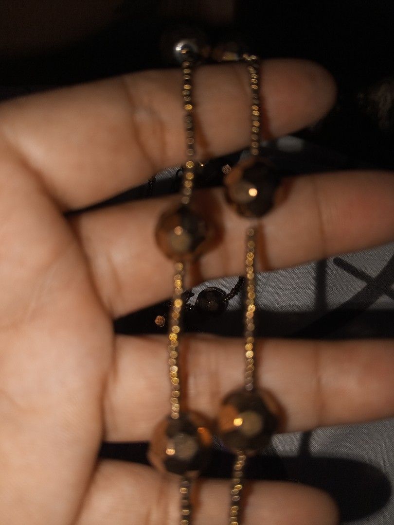 Long Beaded Statement Necklace Bronze Tone (Category: Necklaces) located in Magalang. Submitted by zeiansoria64090 (Listing ID 1464981288, Image 3). Description: - Color: Bronze-toned - Design: Features tiny seed beads and larger faceted metallic beads - Length: Extra long (can be worn single or doubled up) - Closure: Secure lobster clasp - Style Tip: Great for dressing up a simple tee or sweater.