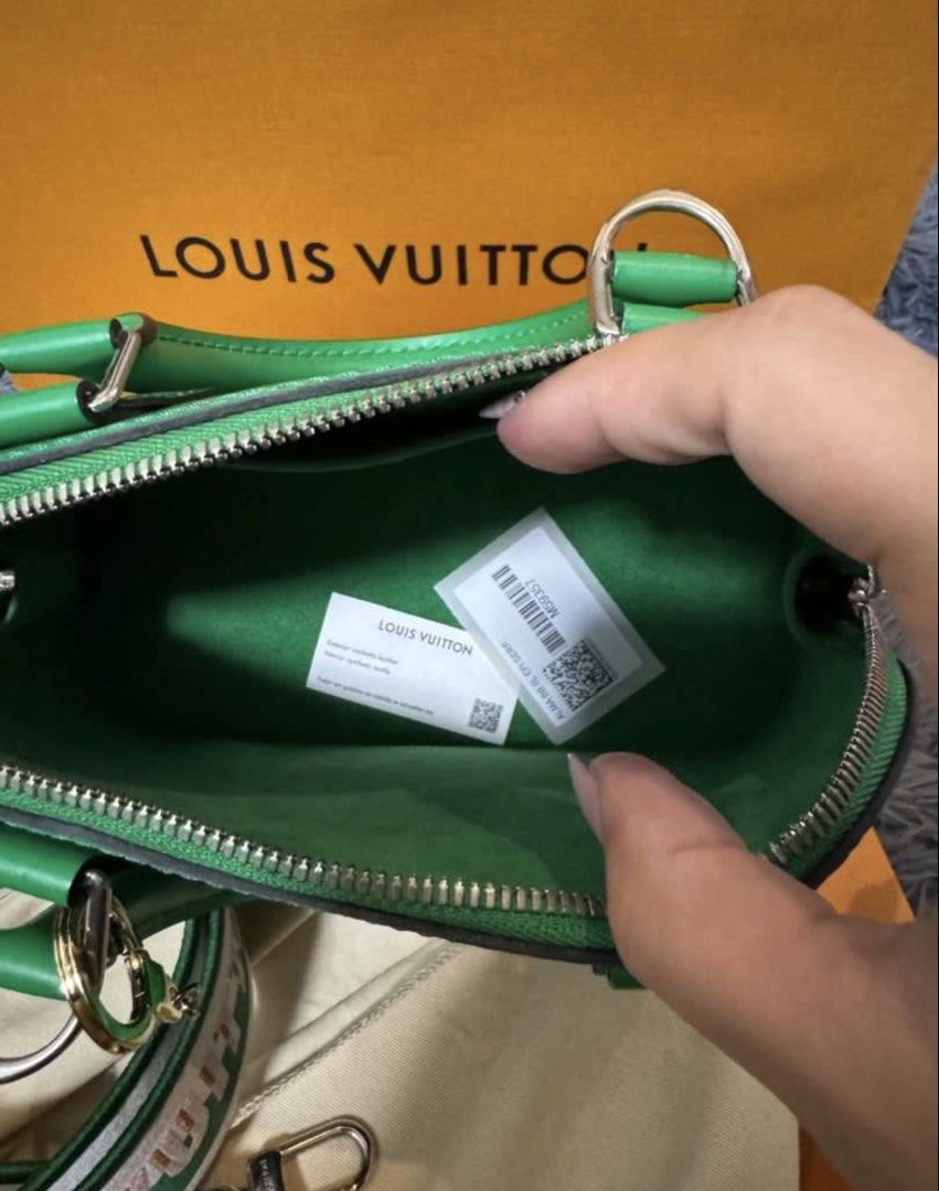 Louis Vuitton Alma BB Epi Green (Category: Luxury Bags & Wallets) located in Quezon City. Submitted by branded_closet01 (Listing ID 1465075141, Image 3). Description: - Authentic Louis Vuitton Alma BB in Green Epi leather - Structured shape with comfortable rolled leather top handles - Sleek silver-tone hardware - Includes a wide, removable canvas shoulder strap with embroidered branding and pink flower accents - Green textile interior lining wit