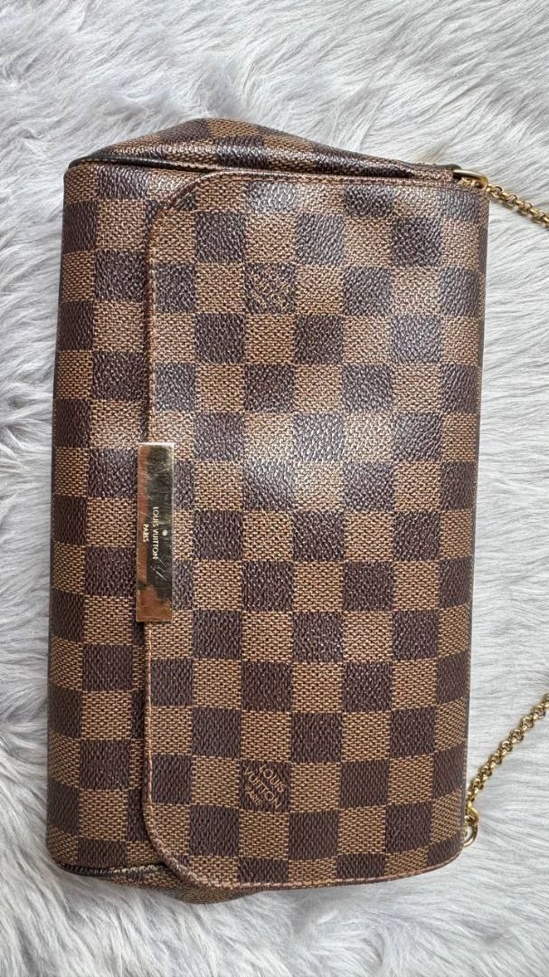 Louis Vuitton Damier Ebene Favorite PM (Category: Luxury Bags & Wallets) located in Manila. Submitted by tmicmd1989 (Listing ID 1465047927, Image 1). Description: - Authentic Louis Vuitton Damier Ebene canvas print - Includes a short gold-tone chain strap plus two leather straps for versatile styling - Flap closure featuring a metal LV-engraved front plaque - Clean structured shape with brown textile-lined interior compartment - Excellent for day