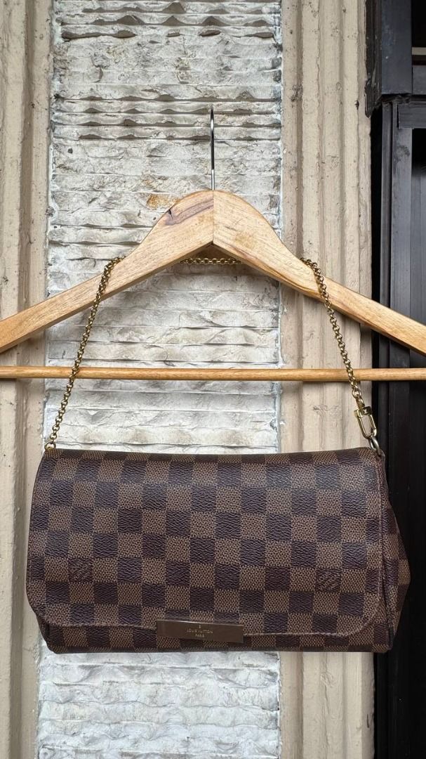 Louis Vuitton Damier Ebene Favorite PM (Category: Luxury Bags & Wallets) located in Manila. Submitted by tmicmd1989 (Listing ID 1465047927, Image 3). Description: - Authentic Louis Vuitton Damier Ebene canvas print - Includes a short gold-tone chain strap plus two leather straps for versatile styling - Flap closure featuring a metal LV-engraved front plaque - Clean structured shape with brown textile-lined interior compartment - Excellent for day