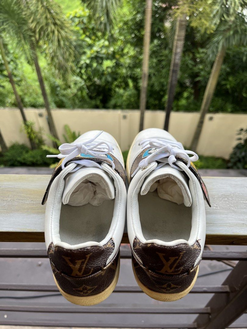 Louis Vuitton Monogram Patch Sneakers White (Category: Sneakers) located in Manila. Submitted by tanfinds (Listing ID 1464986675, Image 2). Description: - Brand: Louis Vuitton - Color: White with colorful mascot monogram strap - Style: Classic low-top leather sneakers - Details: Embossed logo on side and heel counter - Condition: Clean uppers with light toe creasing; moderate dirt on white rubber soles from walking - Inclusions: Original white la