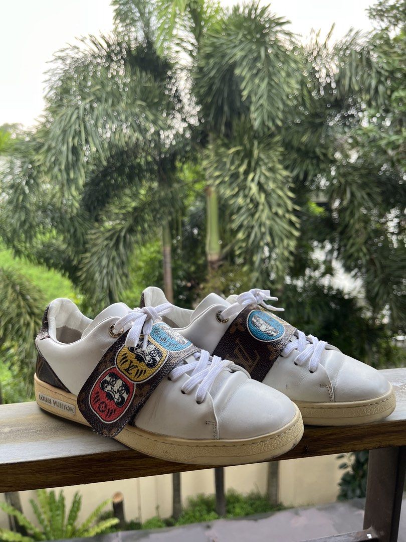 Louis Vuitton Monogram Patch Sneakers White (Category: Sneakers) located in Manila. Submitted by tanfinds (Listing ID 1464986675, Image 1). Description: - Brand: Louis Vuitton - Color: White with colorful mascot monogram strap - Style: Classic low-top leather sneakers - Details: Embossed logo on side and heel counter - Condition: Clean uppers with light toe creasing; moderate dirt on white rubber soles from walking - Inclusions: Original white la