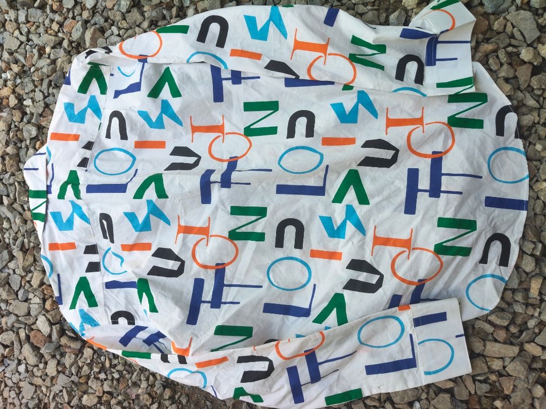 Louis Vuitton Multi-Color Monogram Letter Print Button-Down Shirt (Category: Luxury Apparel) located in Caloocan City. Submitted by balizaclar77072 (Listing ID 1465167761, Image 3). Description: - Authentic Louis Vuitton white button-down shirt - Eye-catching colorful abstract letter print in blue, orange, green, and black - Classic long sleeves, standard collar, and front button closure - Features original Louis Vuitton tags and custom branded b