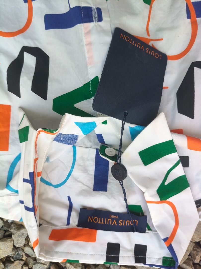 Louis Vuitton Multi-Color Monogram Letter Print Button-Down Shirt (Category: Luxury Apparel) located in Caloocan City. Submitted by balizaclar77072 (Listing ID 1465167761, Image 2). Description: - Authentic Louis Vuitton white button-down shirt - Eye-catching colorful abstract letter print in blue, orange, green, and black - Classic long sleeves, standard collar, and front button closure - Features original Louis Vuitton tags and custom branded b
