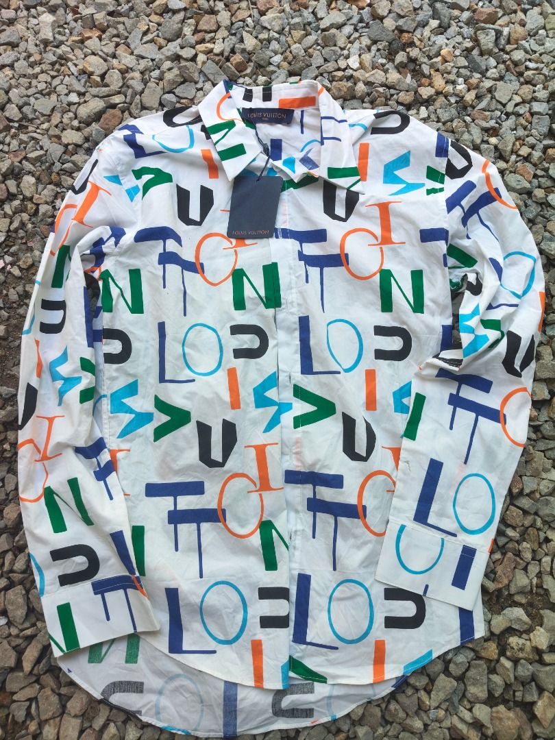 Louis Vuitton Multi-Color Monogram Letter Print Button-Down Shirt (Category: Luxury Apparel) located in Caloocan City. Submitted by balizaclar77072 (Listing ID 1465167761, Image 1). Description: - Authentic Louis Vuitton white button-down shirt - Eye-catching colorful abstract letter print in blue, orange, green, and black - Classic long sleeves, standard collar, and front button closure - Features original Louis Vuitton tags and custom branded b