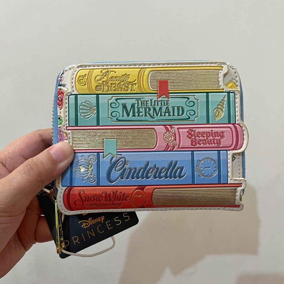 Loungefly Disney Princess Book Stack Zip Around Wallet (Category: Wallets & Card holders) located in San Pedro. Submitted by rainyydayy (Listing ID 1464856365, Image 1). Description: With flaw sa back side (slice) see photo.