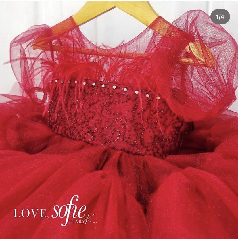 Love Sofie by Jaryk Red Tutu Dress (Category: Babies & Kids Fashion) located in Daraga. Submitted by iamsupershein (Listing ID 1465077640, Image 3). Description: - Brand: Love Sofie by Jaryk - Color: Bright red (ideal for holiday parties and special occasions) - Design: Puffy tulle skirt with a sparkling glitter bodice - Details: Feather-trimmed neckline and sheer puff sleeves - Back Feature: Large detachable sequin bow with a crystal accent - Cl