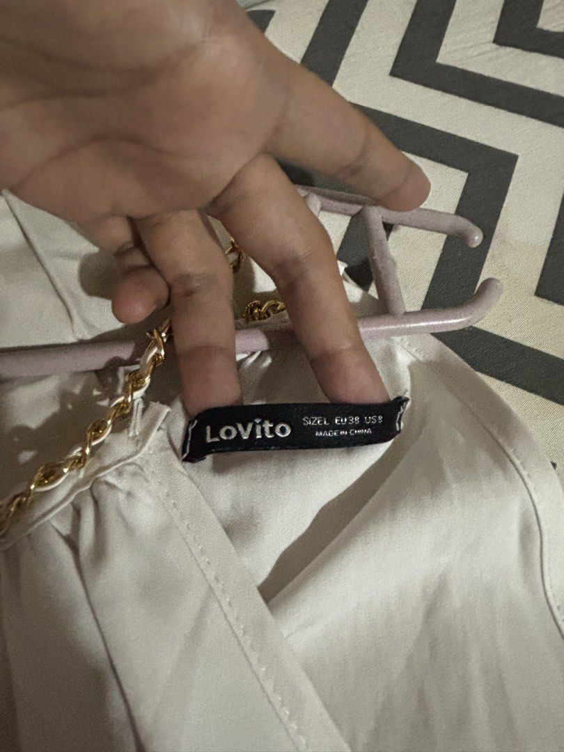 Lovito Women Elegant Plain Metal Basic Jumpsuit (White) (Category: Rompers) located in Mabalacat. Submitted by dj10016 (Listing ID 1464995050, Image 3). Description: - Brand: Lovito - Size: L (EU 38, US 8) - Color: White - Design: Halter neck with gold chain detail, pleated front bodice, fitted waistband, and flared shorts - Closure: Back zipper - Material: Lightweight and easy to style - Condition: Worn twice, excellent shape.