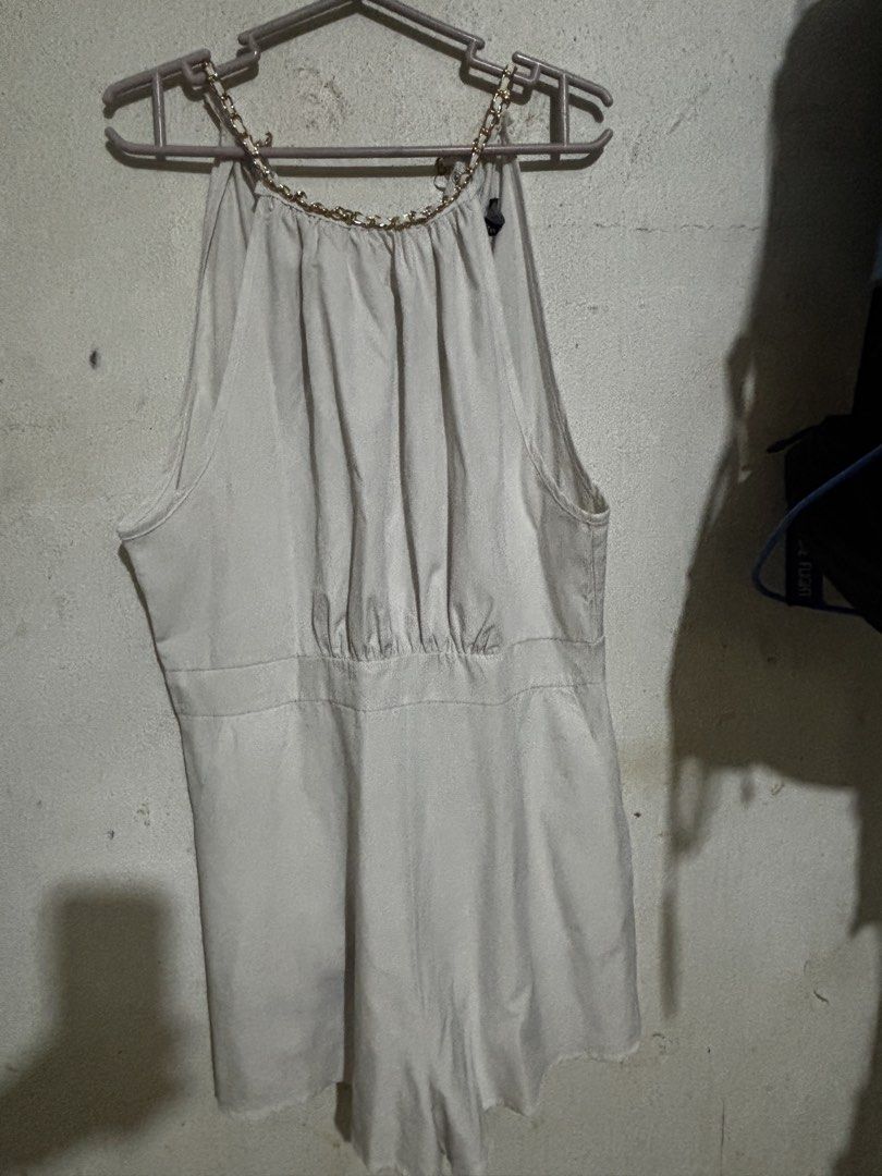 Lovito Women Elegant Plain Metal Basic Jumpsuit (White) (Category: Rompers) located in Mabalacat. Submitted by dj10016 (Listing ID 1464995050, Image 1). Description: - Brand: Lovito - Size: L (EU 38, US 8) - Color: White - Design: Halter neck with gold chain detail, pleated front bodice, fitted waistband, and flared shorts - Closure: Back zipper - Material: Lightweight and easy to style - Condition: Worn twice, excellent shape.