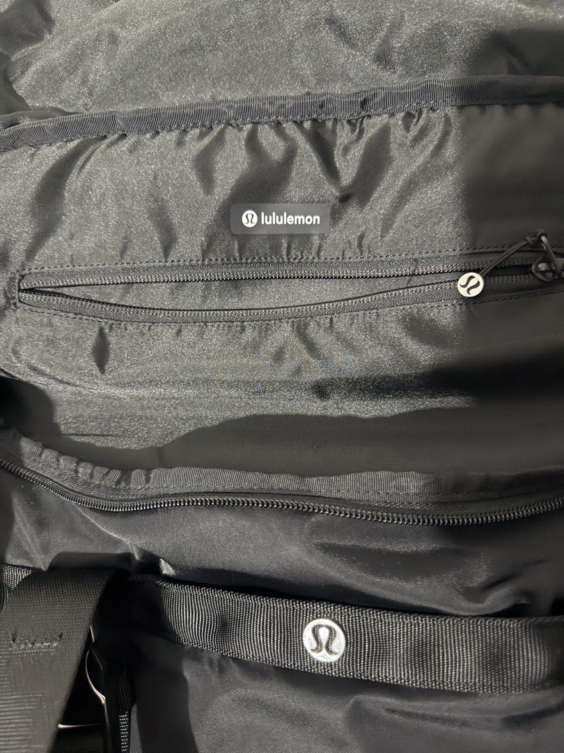 Lululemon Black Travel Duffel Bag (Category: Sling Bags) located in Davao. Submitted by arbeepogio63169 (Listing ID 1465010774, Image 2). Description: - Authentic black Lululemon duffel bag - Ideal size for gym sessions, sports, or short trips (55 x 27.5) - Sturdy, high-quality nylon material for long-lasting use - Multiple zippered compartments inside and out for ultimate organization - Branded metal zipper pulls and interior Lululemon logo patc