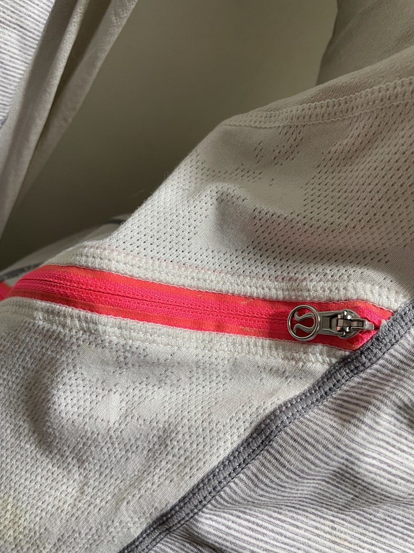 Lululemon Gray Striped Full Zip Activewear Jacket (Category: Coats, Jackets and Outerwear) located in Santiago. Submitted by UkayLuxxSelector (Listing ID 1465074493, Image 3). Description: - Authentic Lululemon activewear jacket - Color: Gray with white stripes and vibrant pink zippers - Features: High collar, secure zip pockets, and convenient thumbholes on cuffs - Breathable: Mesh panels under the arms and down the back for ventilation - Detail