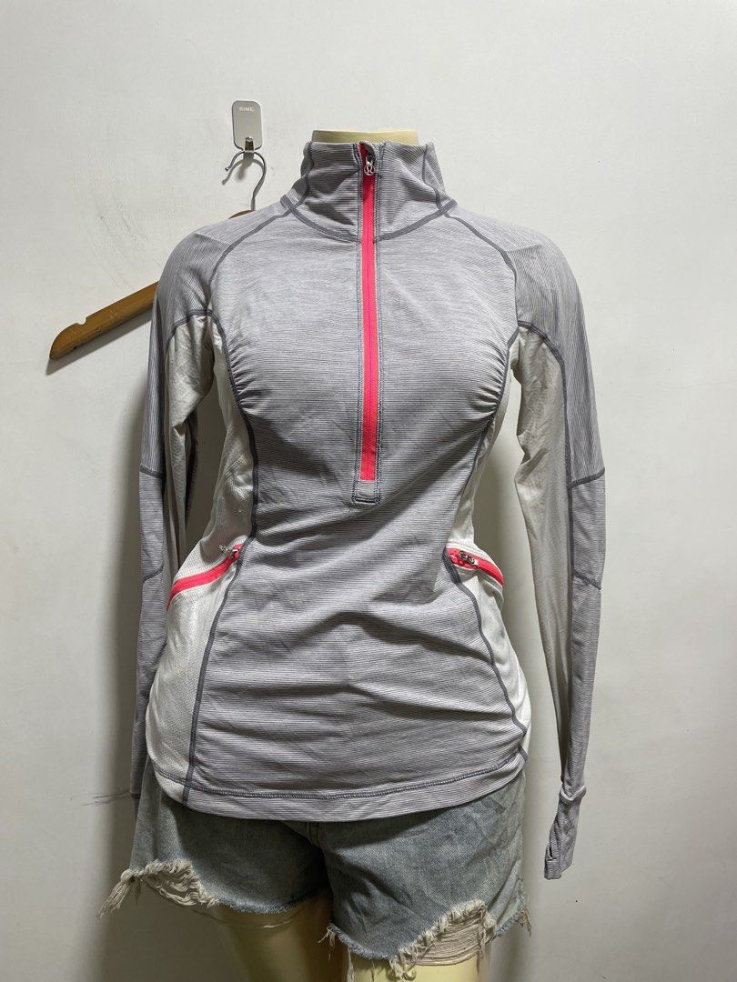 Lululemon Gray Striped Full Zip Activewear Jacket (Category: Coats, Jackets and Outerwear) located in Santiago. Submitted by UkayLuxxSelector (Listing ID 1465074493, Image 1). Description: - Authentic Lululemon activewear jacket - Color: Gray with white stripes and vibrant pink zippers - Features: High collar, secure zip pockets, and convenient thumbholes on cuffs - Breathable: Mesh panels under the arms and down the back for ventilation - Detail