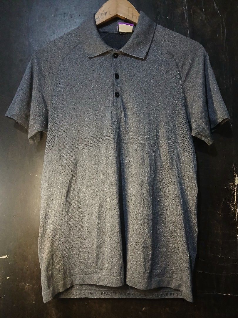 Lululemon Metal Vent Tech Polo Shirt Grey (Category: Tshirts & Polo Shirts ) located in Caloocan City. Submitted by benthriftshp (Listing ID 1465120125, Image 2). Description: - Brand: Lululemon - Color: Grey - Material: Breathable seamless knit with perforated texture - Design: Short sleeves, classic collar, 3-button placket - Detail: Motivational text printed along the lower hem edge - Condition: Excellent, clean, and no flaws PTPA FOR SALE Lul