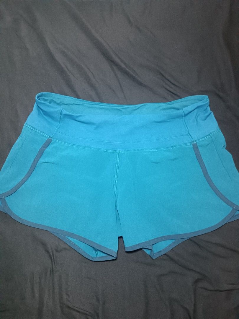 Lululemon Speed Up Shorts Teal Blue Size (Category: Shorts) located in Malasiqui. Submitted by jom_mc.thrift (Listing ID 1465077112, Image 3). Description: - Brand: Lululemon - Color: Teal blue with dark trim contrast - Style: Lightweight athletic running shorts with built-in liner - Waist: High-rise waistband for comfortable support - Features: Secure back zip pocket with reflective zipper pull and signature silver omega logo dimension w:30-32 L