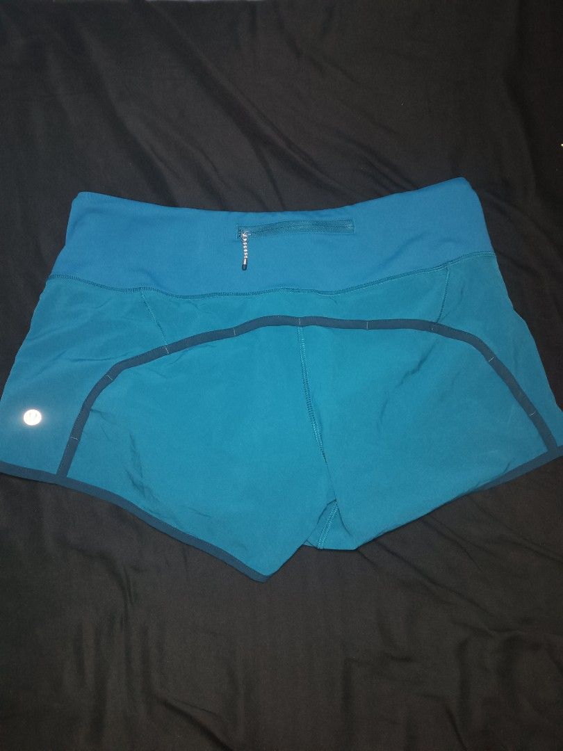 Lululemon Speed Up Shorts Teal Blue Size (Category: Shorts) located in Malasiqui. Submitted by jom_mc.thrift (Listing ID 1465077112, Image 2). Description: - Brand: Lululemon - Color: Teal blue with dark trim contrast - Style: Lightweight athletic running shorts with built-in liner - Waist: High-rise waistband for comfortable support - Features: Secure back zip pocket with reflective zipper pull and signature silver omega logo dimension w:30-32 L