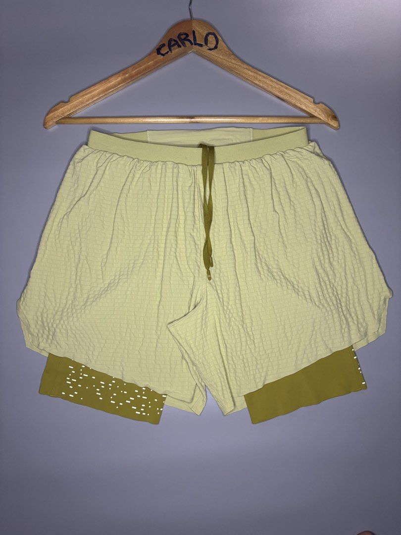 LULULEMON SURGE LINED SHORT 6 "SPECIAL EDITION (Category: Shorts) located in Bayambang. Submitted by lo_keythrifting (Listing ID 1465007861, Image 3). Description: ✅ LULULEMON SURGE LINED SHORT 6 "SPECIAL EDITION - Condition: Good as new condition - Waist: 26-34 - Length: 13 - Color rate: 10/10 - No issue - Dual-layer design: Light yellow-green grid-textured outer layer and darker olive yellow inner liner with perforated dots - Elastic waistband 