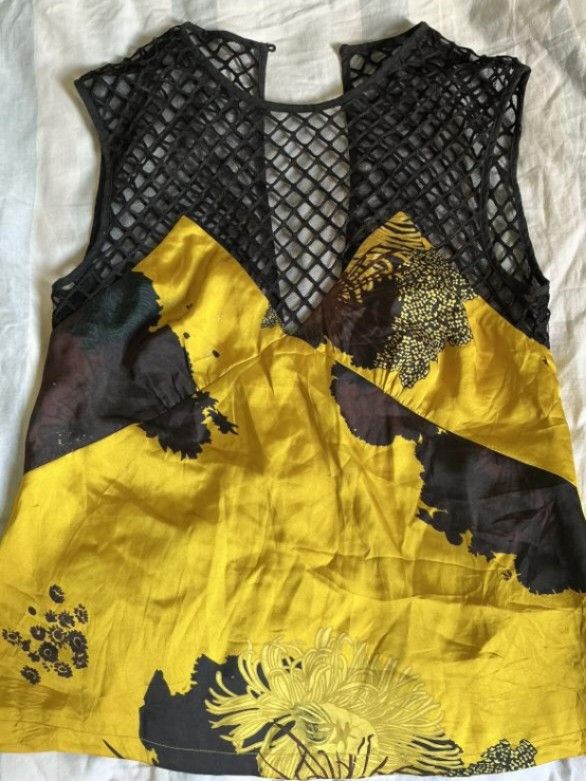 MADEINAM Preloved Mesh & Yellow Floral Statement Top (Worn Once) (Category: Others Tops) located in Manila. Submitted by ellee.stone (Listing ID 1465074987, Image 1). Description: Selling this gorgeous, hard-to-find statement piece from MADEINAM. It features a stunning, vibrant yellow abstract floral graphic print on smooth satin-feel fabric, beautifully paired with a structured black diamond-mesh fishnet yoke. The plunging V-neckline styling loo