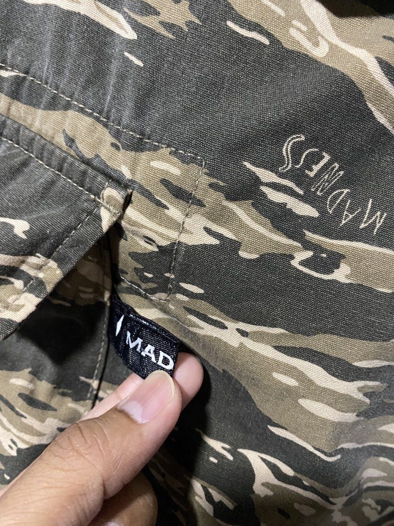 MADNESS Tiger Stripe Camo Cargo Shorts (Category: Shorts) located in Tanay. Submitted by judevalcorza (Listing ID 1465108625, Image 3). Description: - Brand: MADNESS - Small 30/32 length 19 - Design: Tiger stripe camouflage with signature brand tags - Material: Durable heavyweight cotton - Pockets: Multiple utility pockets with button flaps (sides and back) - Fit: Adjustable waist tabs on both sides for a customized fit - Details: Trendy cut-off 