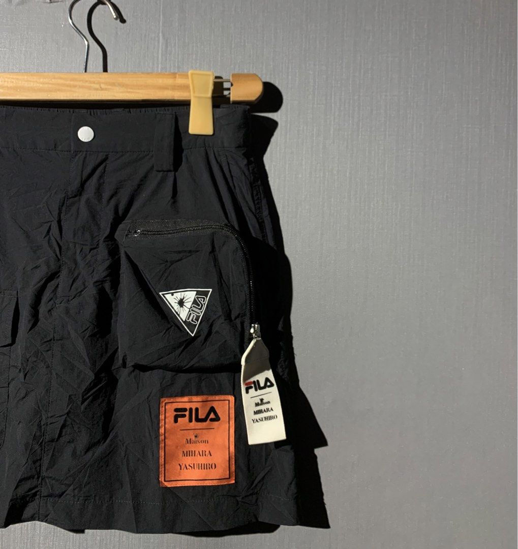 Maison Mihara X Fila (Category: Luxury Apparel) located in Bacolod City. Submitted by garagehunterbuyandsale (Listing ID 1465055017, Image 2). Description: utility skirt features a striking orange FILA x Maison Mihara Yasuhiro co-branded patch that stands out against the crinkled nylon fabric size 26-27 actual waistline & 16 length .