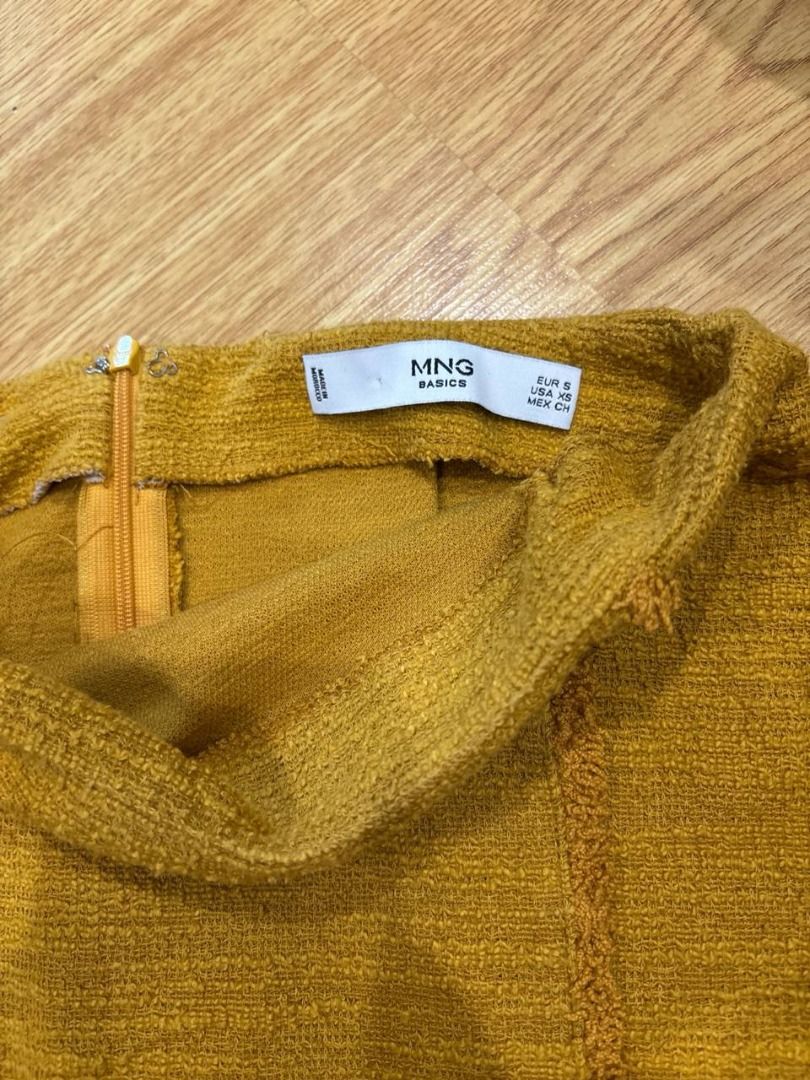 Mango Basics mustard yellow textured (Category: Skirts) located in Pasig City. Submitted by ysabellyyyyy (Listing ID 1465036055, Image 2). Description: - Brand: Mango Basics - Color: Mustard Yellow - Size: EUR S / USA XS / MEX CH - Closure: Back zipper - Details: Textured fabric with stylish raw seam front accents - Styling: Easy to mix and match with basic tees or cozy knitwear.