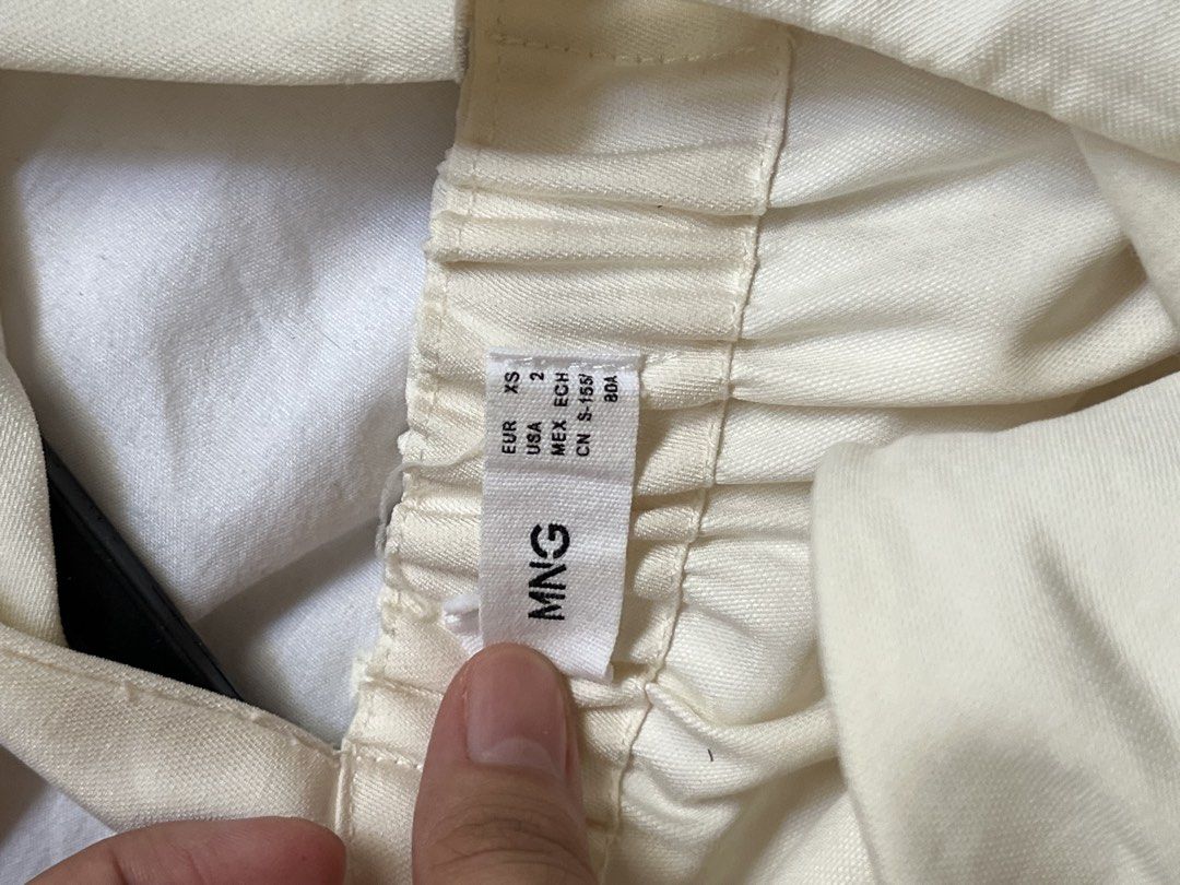 Mango Cream Dress XS (Category: Dresses) located in Manila. Submitted by tidymarket (Listing ID 1464999432, Image 3). Description: - Brand: Mango - Size: EUR XS / USA 2 - Color: Off-white - Design: Criss-cross back straps, tiered skirt - Closure: Side zipper - Condition: Slight tear on the left strap but can be mended .