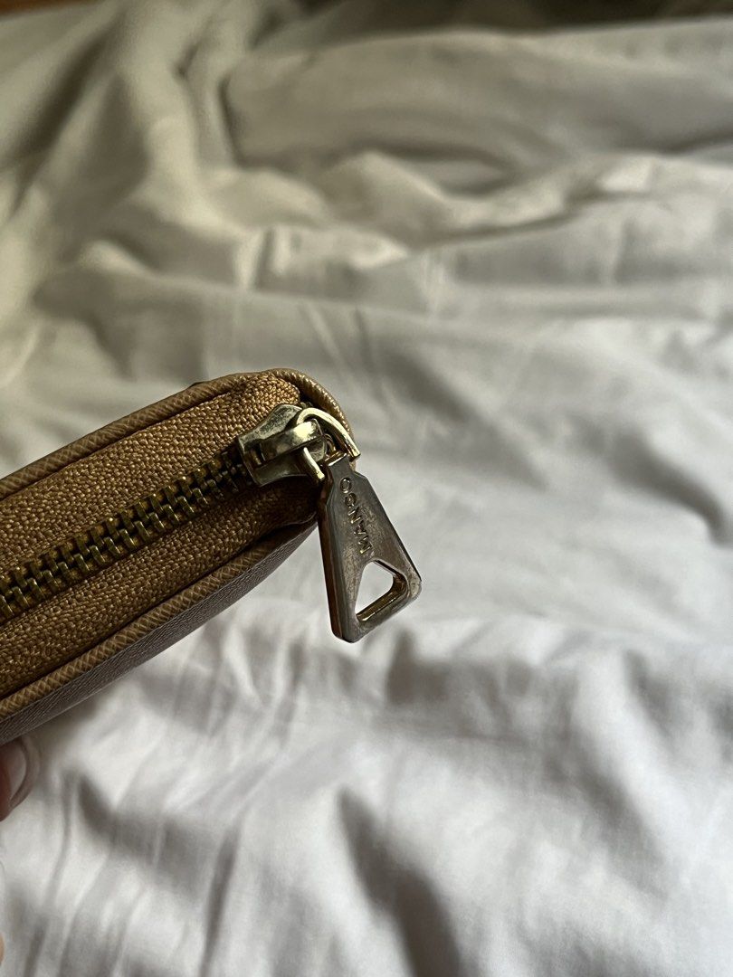 Mango Long Wallet Brown (Category: Wallets & Card holders) located in Manila. Submitted by tidymarket (Listing ID 1464993801, Image 2). Description: - Brand/Style: Mango camel long wallet - Material & Hardware: Textured saffiano material with chic gold-tone hardware and front stud details - Closure: Secure zip-around closure with an engraved pull tab - Interior: Clean black interior featuring multiple card slots, slip compartments, and a center z