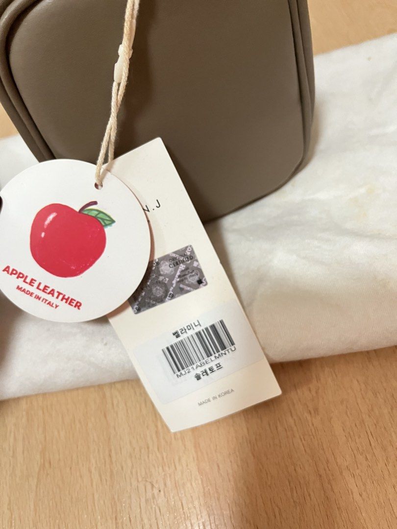MARHEN.J Bella Mini Bag in Taupe (Category: Luxury Bags & Wallets) located in Pasig City. Submitted by declutterskt (Listing ID 1465040659, Image 3). Description: - Brand: MARHEN.J Bella Mini - Color: Taupe - Material: Sustainable Italian apple leather - Hardware: Silver-toned with zip closure - Features: Top handle, detachable crossbody strap, interior fabric lining with logo tag - Condition: Brand new, unused, original tags attached, stuffed wi