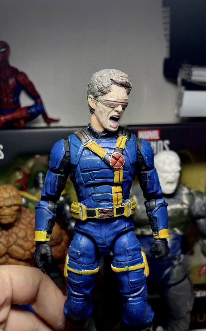 Marvel Legends Cyclops X-Men Action Figure Custom Paint (Category: Figurines & Statues) located in Manila. Submitted by josegabrie09118 (Listing ID 1465037459, Image 3). Description: - Custom painted Cyclops action figure - Blue and yellow tactical uniform with detailed straps, pouches, and red X logo - Visor sculpt with dynamic open yelling expression - Fully articulated joints at the shoulders, elbows, and knees - Hand-painted details and weath