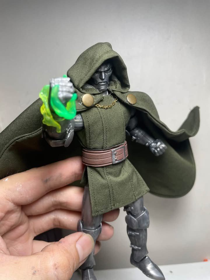 Marvel Legends Doctor Doom Action Figure with Custom Head (Category: Figurines & Statues) located in Manila. Submitted by josegabrie09118 (Listing ID 1465036357, Image 1). Description: - Custom Marvel Legends Doctor Doom action figure - Includes alternate unmasked head sculpt, green soft goods tunic, cape, and magical energy FX parts - Features detailed metallic armor - Perfect for display - Note: Minor glue stain on the fabric tunic..