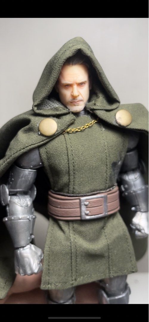 Marvel Legends Doctor Doom Action Figure with Custom Head (Category: Figurines & Statues) located in Manila. Submitted by josegabrie09118 (Listing ID 1465036357, Image 2). Description: - Custom Marvel Legends Doctor Doom action figure - Includes alternate unmasked head sculpt, green soft goods tunic, cape, and magical energy FX parts - Features detailed metallic armor - Perfect for display - Note: Minor glue stain on the fabric tunic..