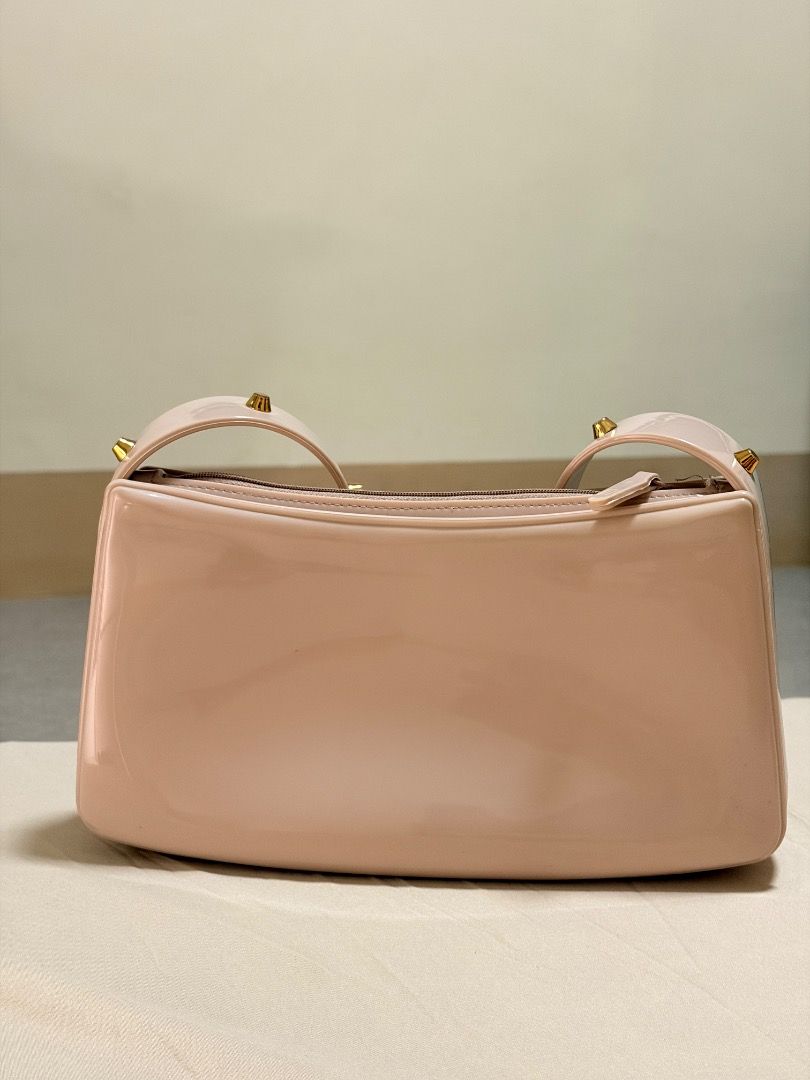 Melissa pink jelly shoulder bag with studs (Category: Shoulder Bags) located in Manila. Submitted by quekrystel35491 (Listing ID 1464987698, Image 2). Description: - Brand: Melissa - Color: Light pink - Material: Water-resistant jelly (easy to wipe clean) - Design: Structured shape, single strap with gold-toned studs, top zip closure, and embossed front logo - Size: Standard (fits daily essentials easily) - Condition: Good, with minor scuff marks