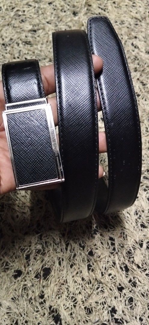 MEN'S BATSU Black Leather Belt (Category: Belts) located in Paranaque City. Submitted by michael-08 (Listing ID 1465168365, Image 1). Description: - Brand/Model: Men's Batsu - Color: Classic Black - Material & Texture: Premium leather with Saffiano texture pattern - Hardware: Silver-tone metal buckle with engraved branding - Design: Clean edges and sturdy build for long-lasting wear - Versatility: Ideal for business casual and formal outfits - Co