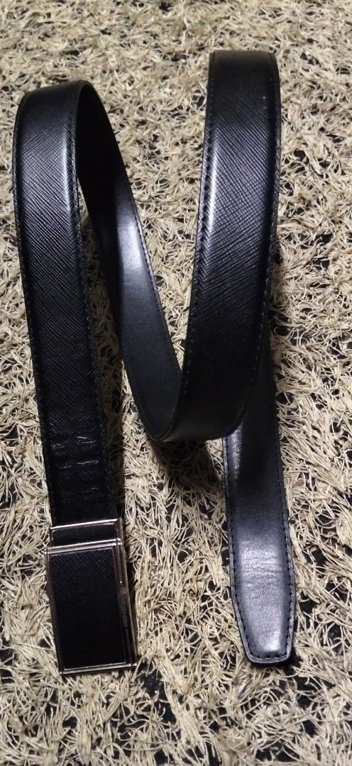 MEN'S BATSU Black Leather Belt (Category: Belts) located in Paranaque City. Submitted by michael-08 (Listing ID 1465168365, Image 3). Description: - Brand/Model: Men's Batsu - Color: Classic Black - Material & Texture: Premium leather with Saffiano texture pattern - Hardware: Silver-tone metal buckle with engraved branding - Design: Clean edges and sturdy build for long-lasting wear - Versatility: Ideal for business casual and formal outfits - Co